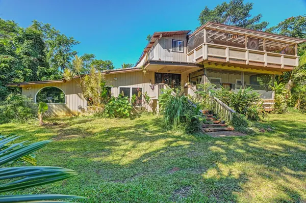 a view of a house with a garden and plants