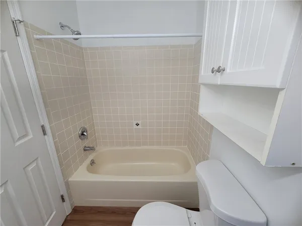 a bathroom with a toilet and bathtub