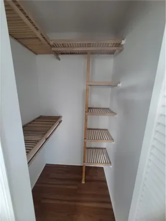 a view of a room with wooden floor
