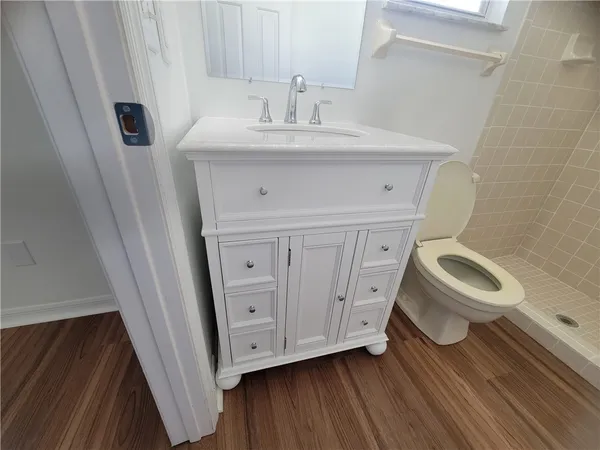 a bathroom with a sink a toilet and a mirror