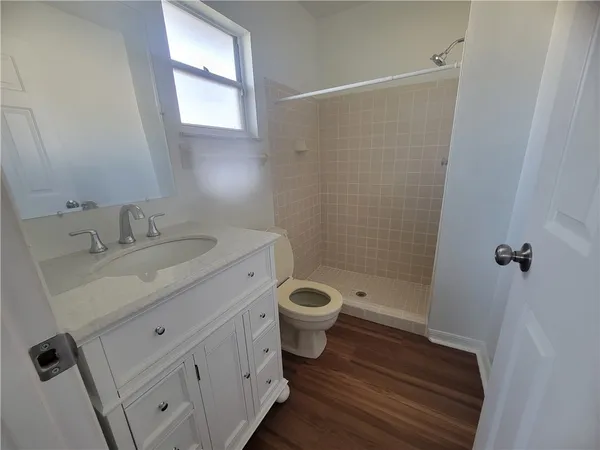 a bathroom with a toilet sink and shower