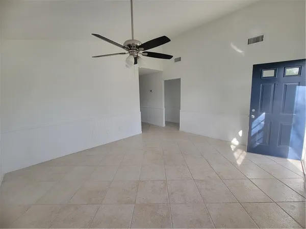 a view of an empty room with a fan