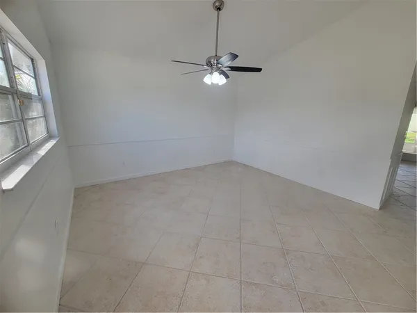 a view of a livingroom with a ceiling fan and window