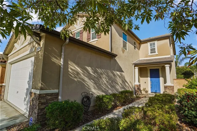 a house that has a tree in front of the house
