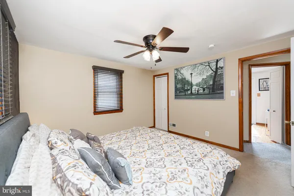 a bedroom with bed and a window