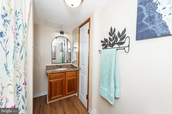 a room with painting on the wall and a wooden floor