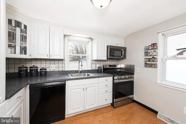 a kitchen with a sink stove and microwave