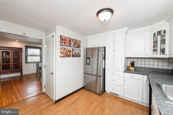 a kitchen with stainless steel appliances a refrigerator sink and cabinets