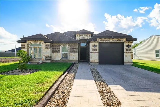 a front view of a house with a yard