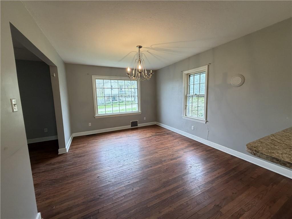 1146 Franklin Road Jackson Center, PA 16133 - Photo 9 of 19 an empty room with wooden floor and windows