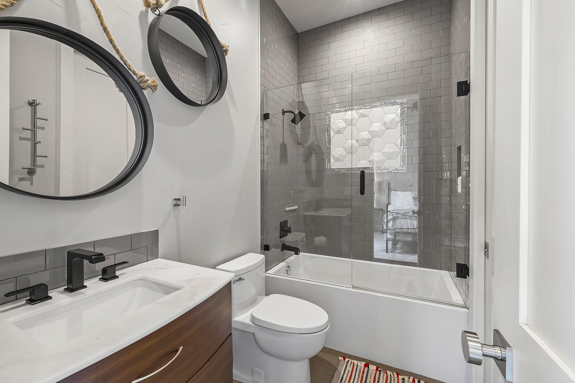 2414 Kinney Road Austin, TX 78704 - Photo 18 of 40 a bathroom with a sink a toilet and a mirror