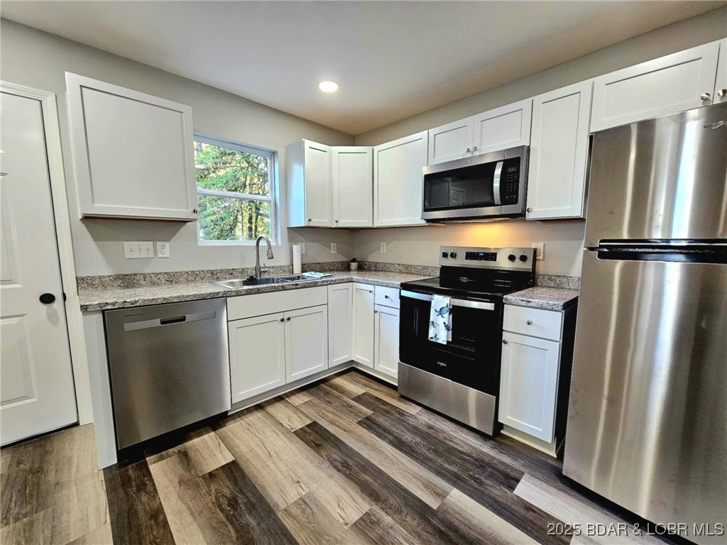 4861 University Lane Osage Beach, MO 65065 - Photo 3 of 31 Kitchen with stainless steel sink and appliances.