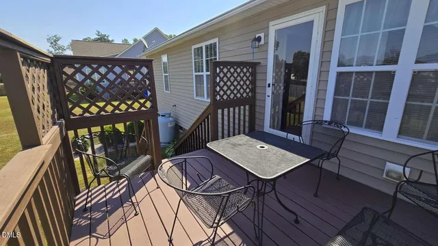 a view of roof deck with two chairs and a table