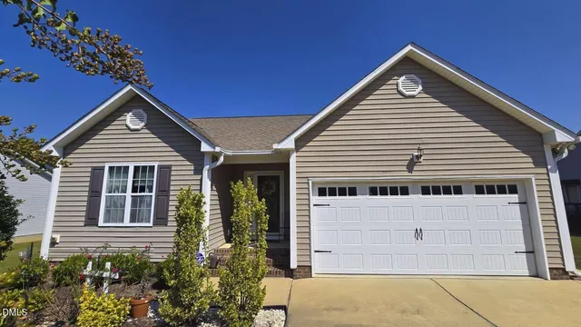 a view of a house with wooden fence