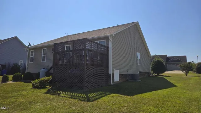 a backyard of a house with yard and trampoline