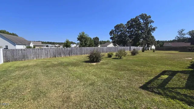 a view of a house with backyard and deck