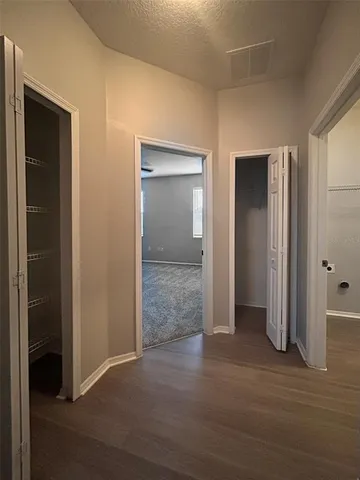 an empty room with closet and a bathroom