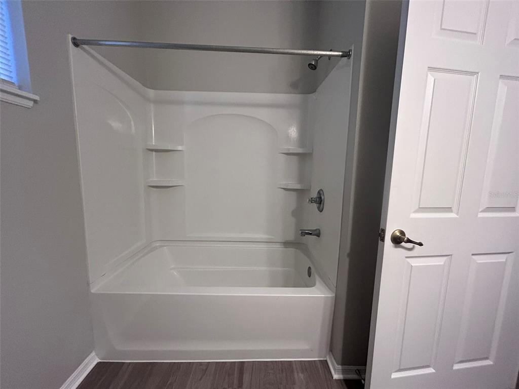 4432 Barbados Loop Clermont, FL 34711 - Photo 17 of 19 a bathroom with a bathtub