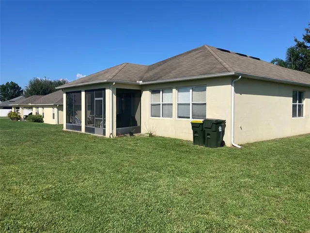 a house with huge green field in front of it