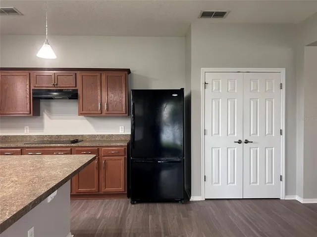 a kitchen with a refrigerator and a sink