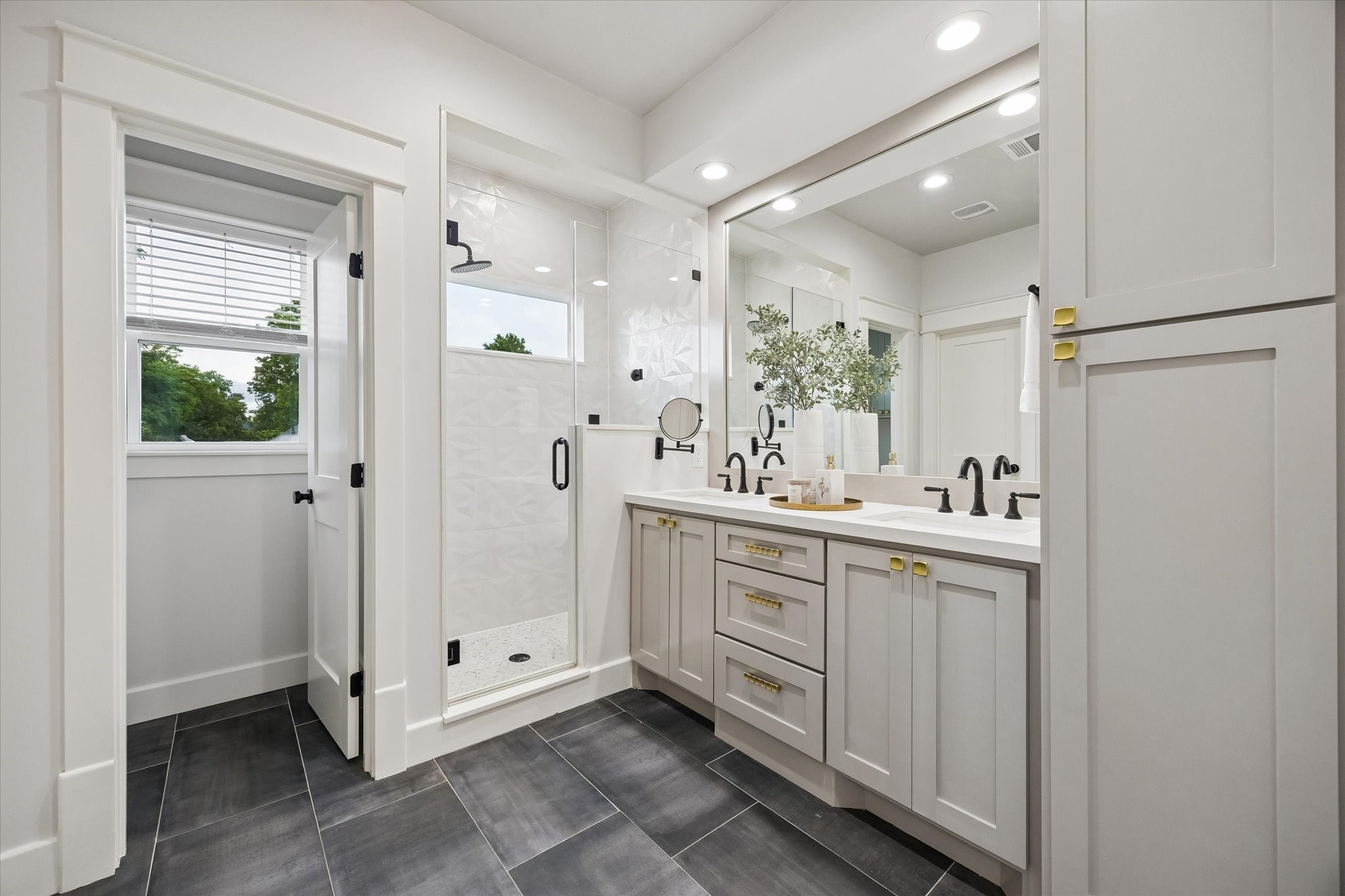 910 Northwood Street Houston, TX 77009 - Photo 18 of 28 a bathroom with a double vanity sink and mirror