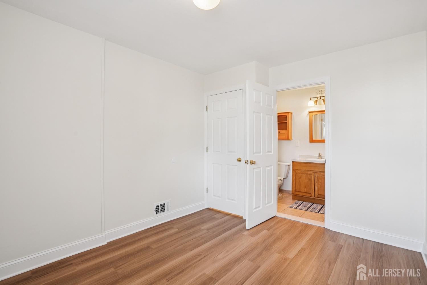 12 Brookville Road Edison, NJ 08817 - Photo 11 of 25 a view of an empty room with wooden floor and a window