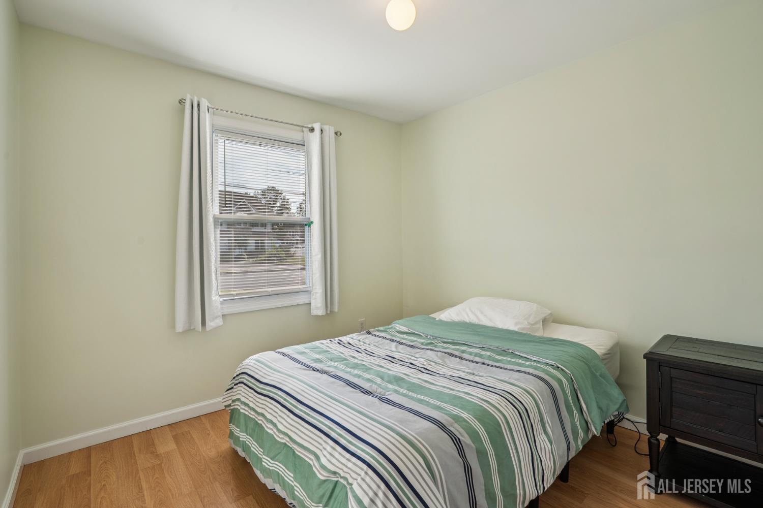 12 Brookville Road Edison, NJ 08817 - Photo 15 of 25 a bedroom with a bed and wooden floor