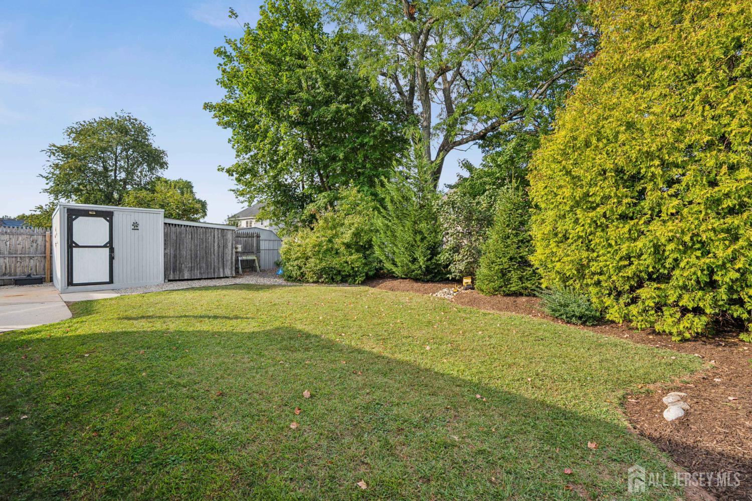12 Brookville Road Edison, NJ 08817 - Photo 23 of 25 a view of a backyard with a large tree