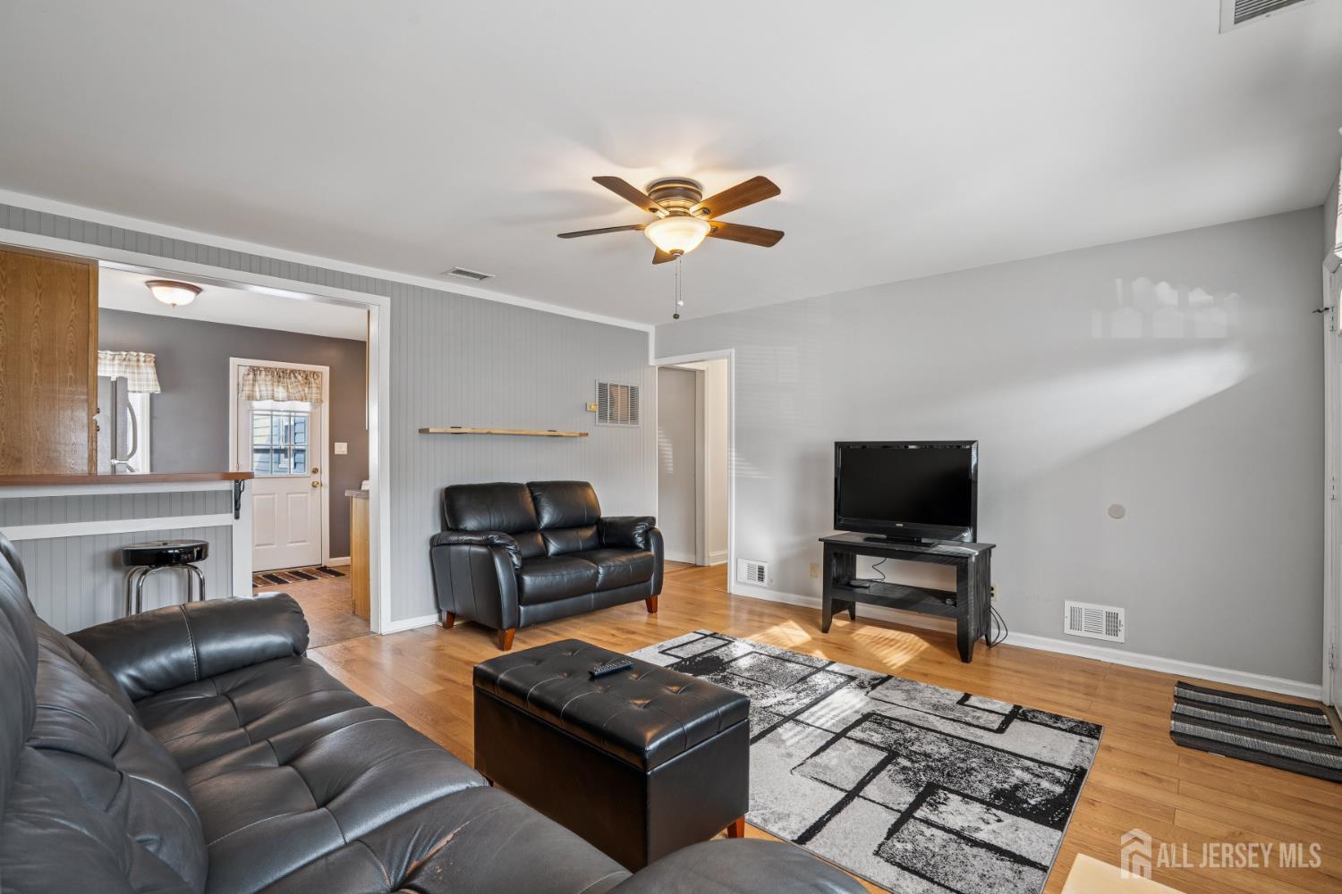 12 Brookville Road Edison, NJ 08817 - Photo 4 of 25 a living room with furniture a fireplace and a flat screen tv