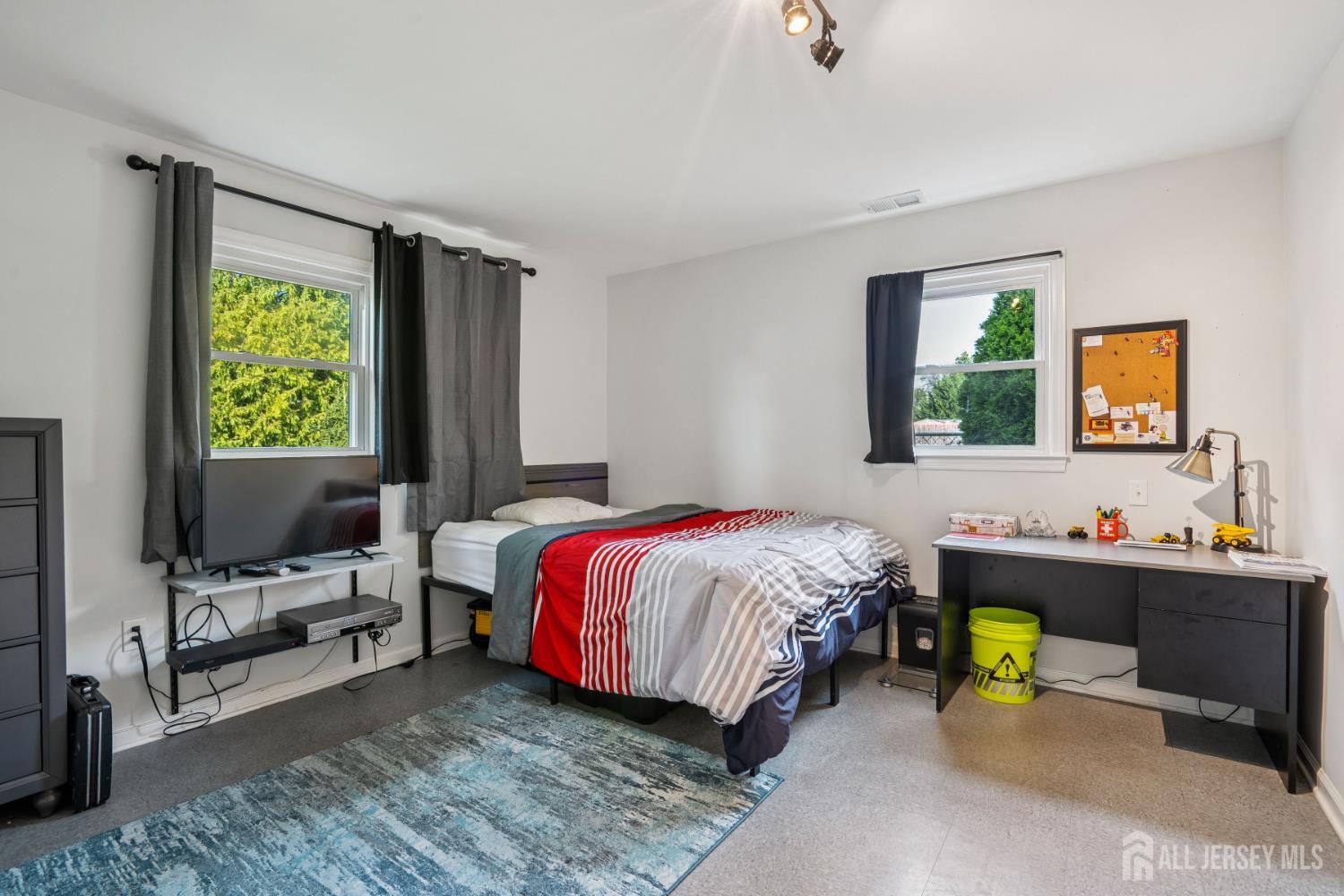 12 Brookville Road Edison, NJ 08817 - Photo 9 of 25 a bedroom with a bed and a desk