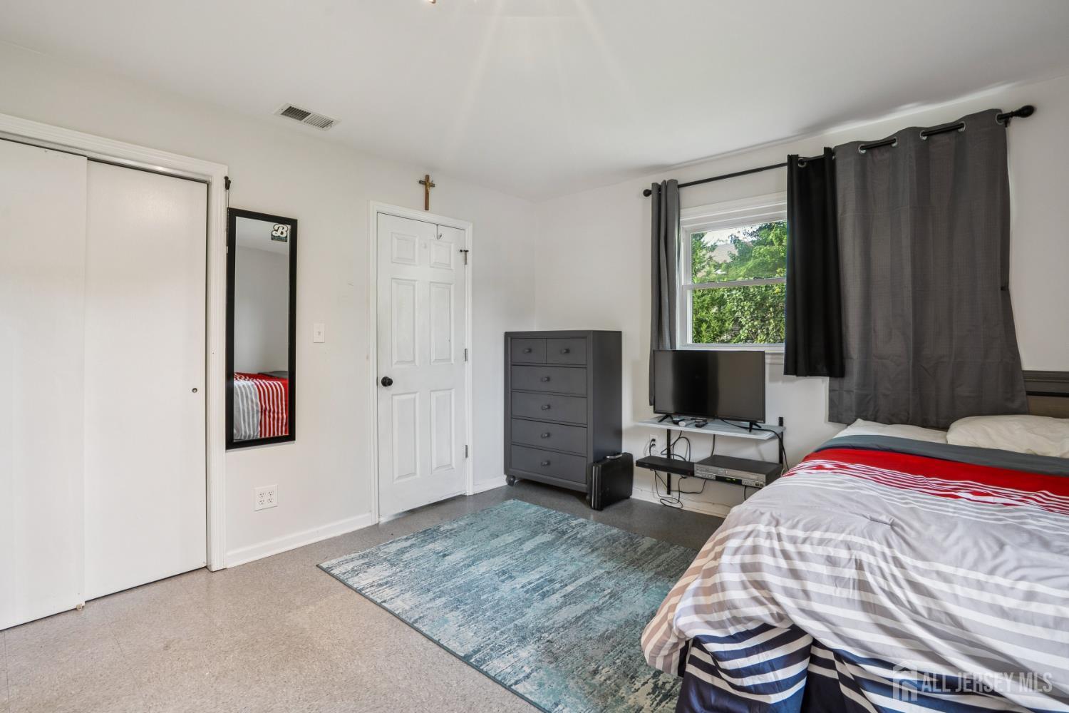 12 Brookville Road Edison, NJ 08817 - Photo 10 of 25 a bedroom with a bed and wooden floor