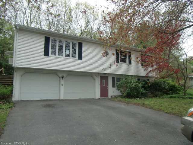 409 County Road Torrington, CT 06790 - Photo 1 of 1 a front view of a house with a yard and garage
