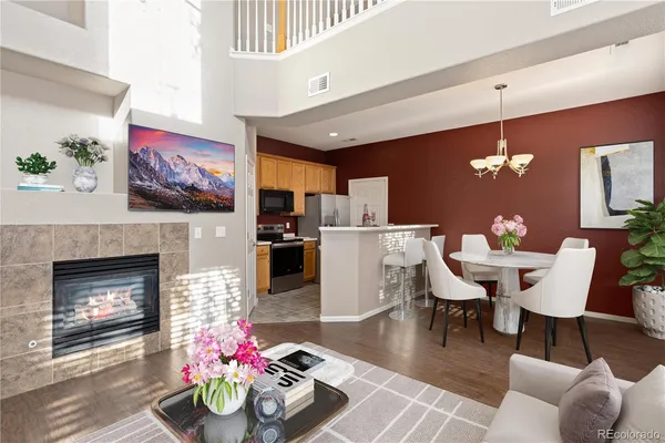 a dining room with furniture a fireplace and a chandelier