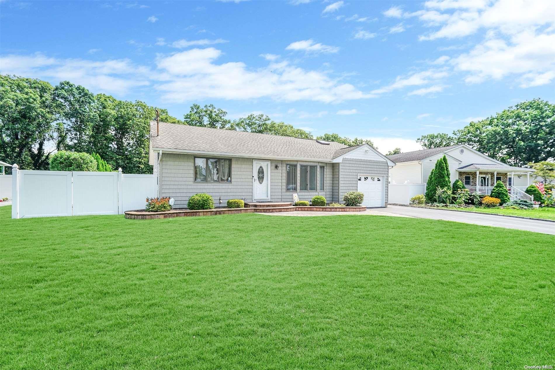 21 Seusing Boulevard Ronkonkoma, NY 11779 - Photo 1 of 1 a front view of a house with a yard