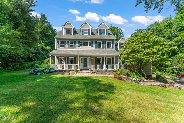 a view of a house with a yard table and chairs