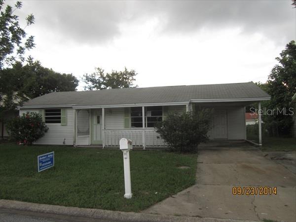 6437 Reno Avenue New Port Richey, FL 34653 - Photo 1 of 1 a front view of a house with a yard and garage