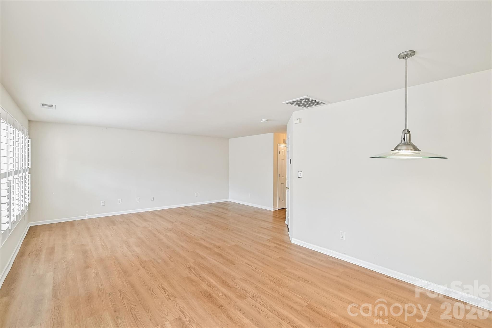 4160 Segundo Lane Fort Mill, SC 29707 - Photo 2 of 30 a view of empty room with wooden floor and fan