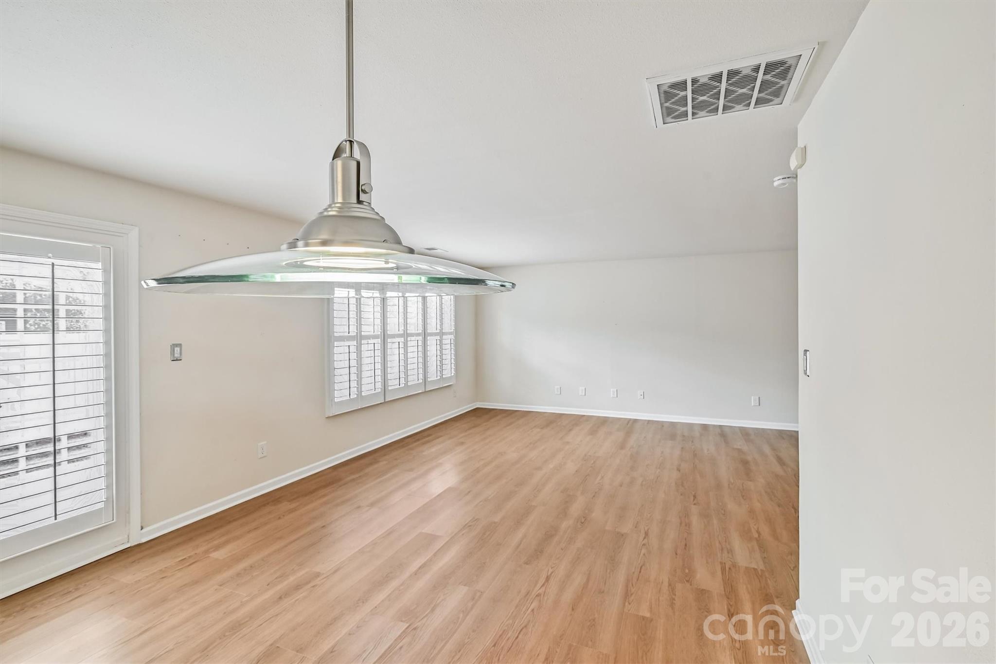 4160 Segundo Lane Fort Mill, SC 29707 - Photo 3 of 30 a view of an empty room with wooden floor and a window