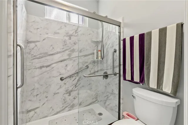 a bathroom with a shower and a toilet