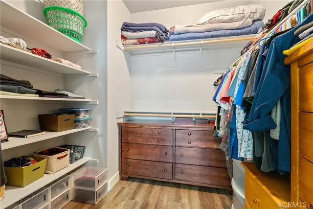 a view of a deck with couches chairs and wooden floor