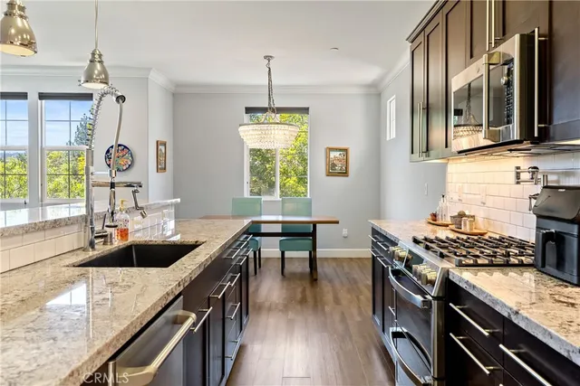 a kitchen with stainless steel appliances granite countertop a stove and a sink