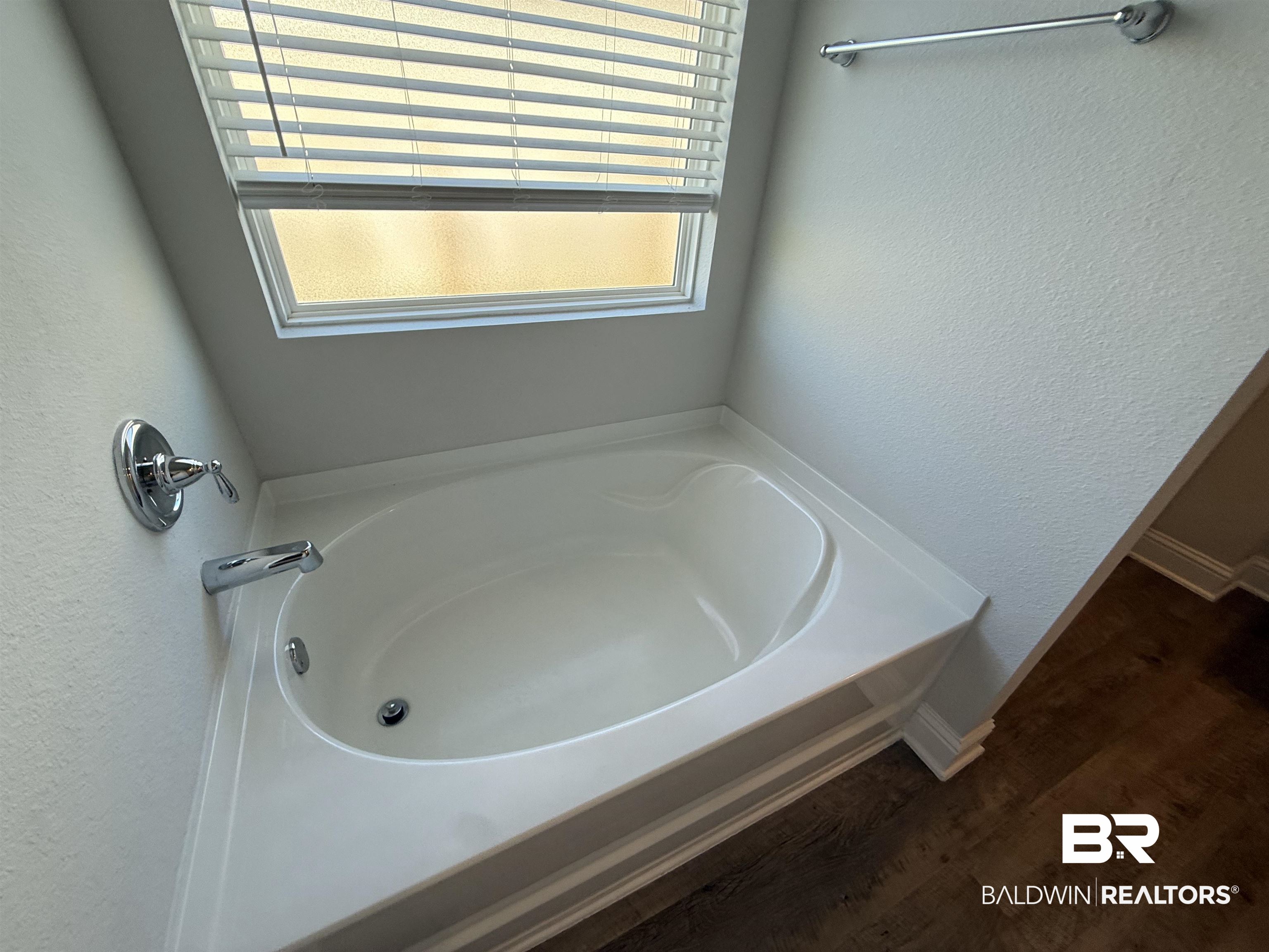 23247 Lieutenant Avenue Foley, AL 36535 - Photo 30 of 47 Built-in soaking tub with chrome fixtures and a privacy window