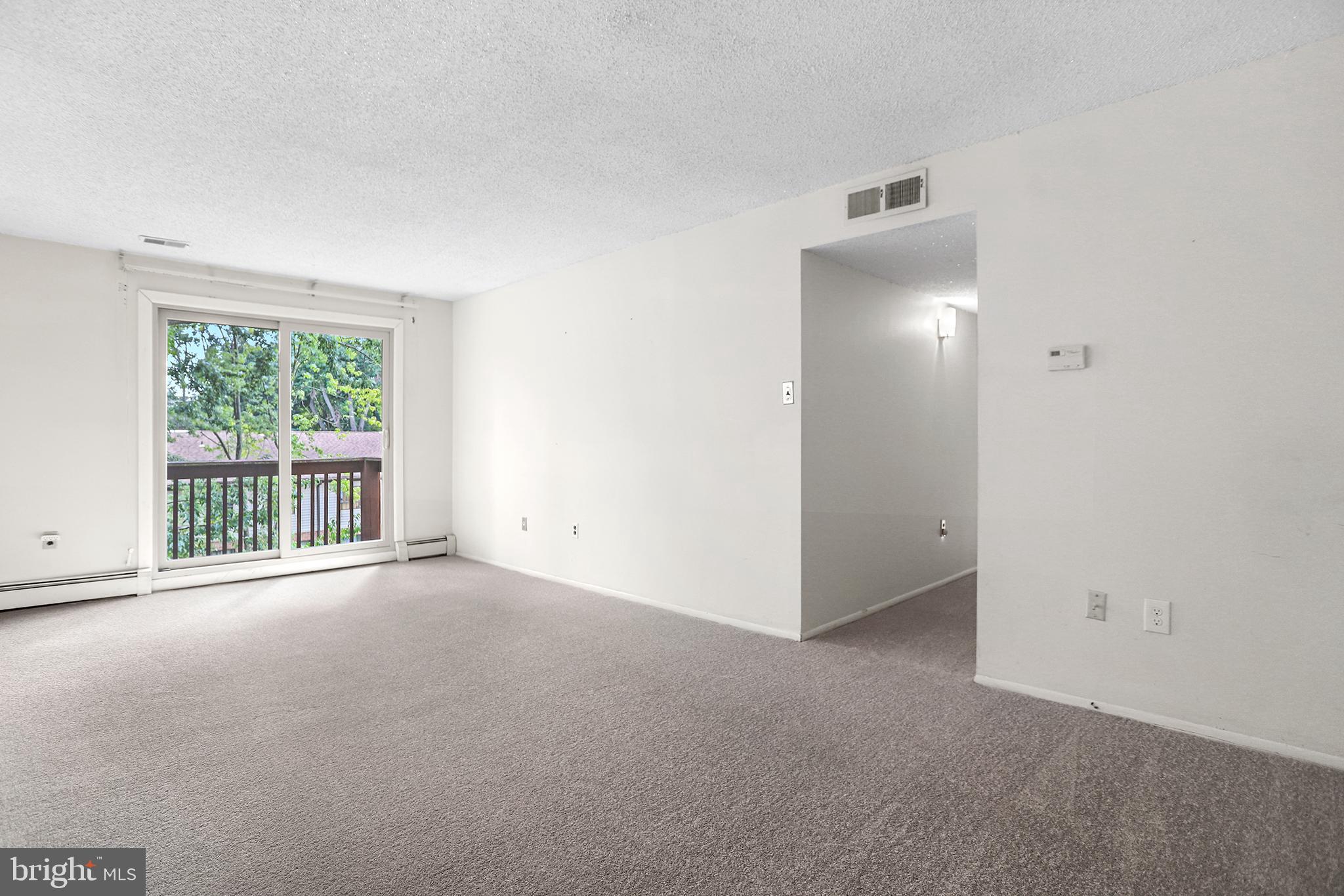 280 Bridgewater Road, Unit D4 Brookhaven, PA 19015 - Photo 3 of 15 an empty room with windows and entrance