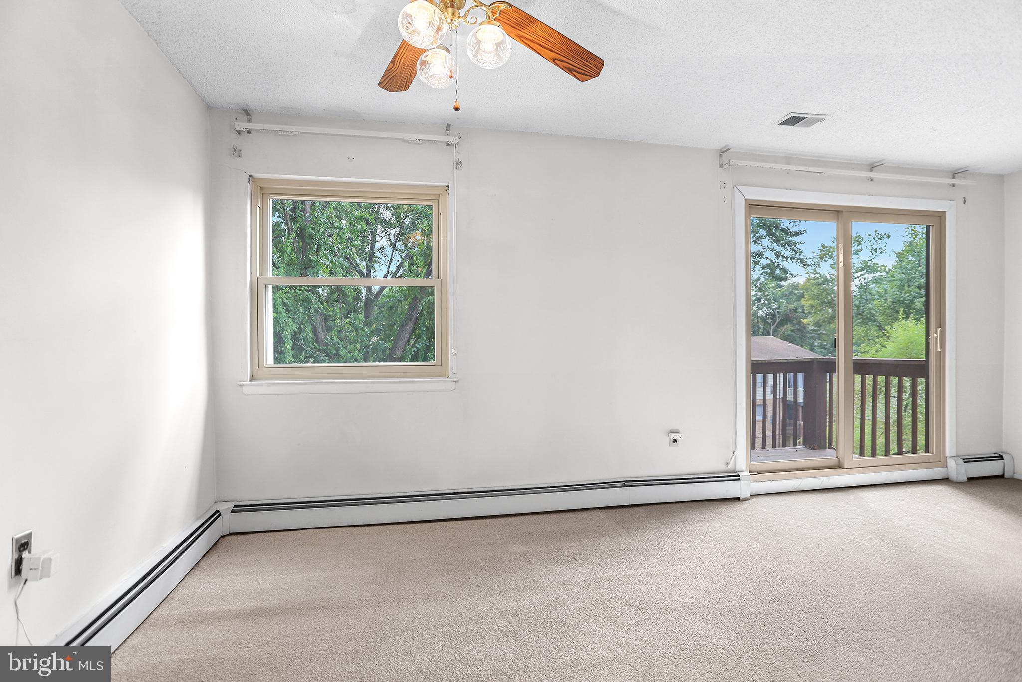 280 Bridgewater Road, Unit D4 Brookhaven, PA 19015 - Photo 6 of 15 an empty room with a empty space and windows