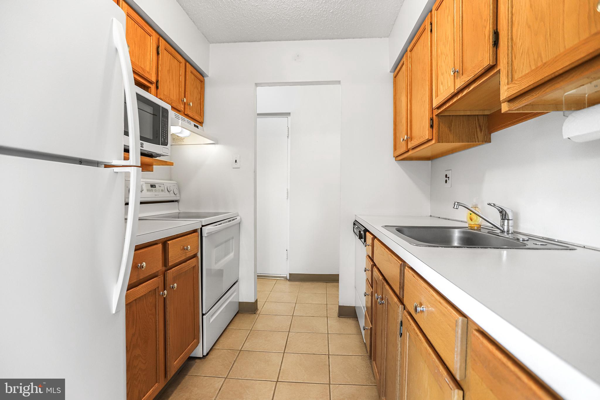 280 Bridgewater Road, Unit D4 Brookhaven, PA 19015 - Photo 7 of 15 a kitchen with stainless steel appliances granite countertop a sink and a stove
