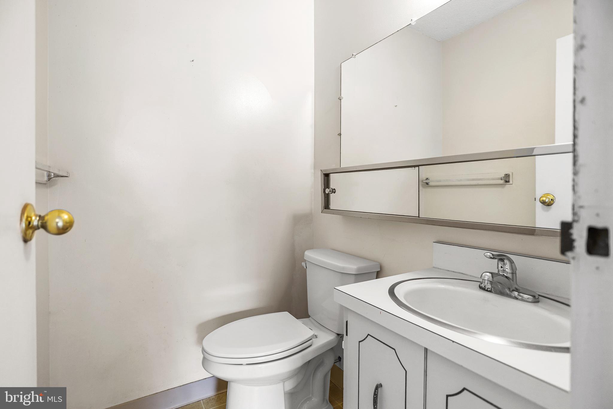 280 Bridgewater Road, Unit D4 Brookhaven, PA 19015 - Photo 9 of 15 a bathroom with a sink a toilet and mirror