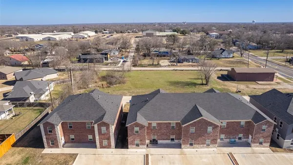 an aerial view of residential houses with outdoor space