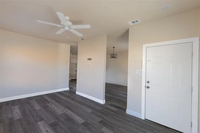 a view of a house with a wooden fence