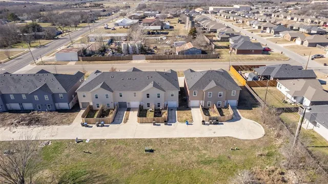 an aerial view of a residential houses with outdoor space