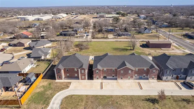 an aerial view of residential houses with outdoor space